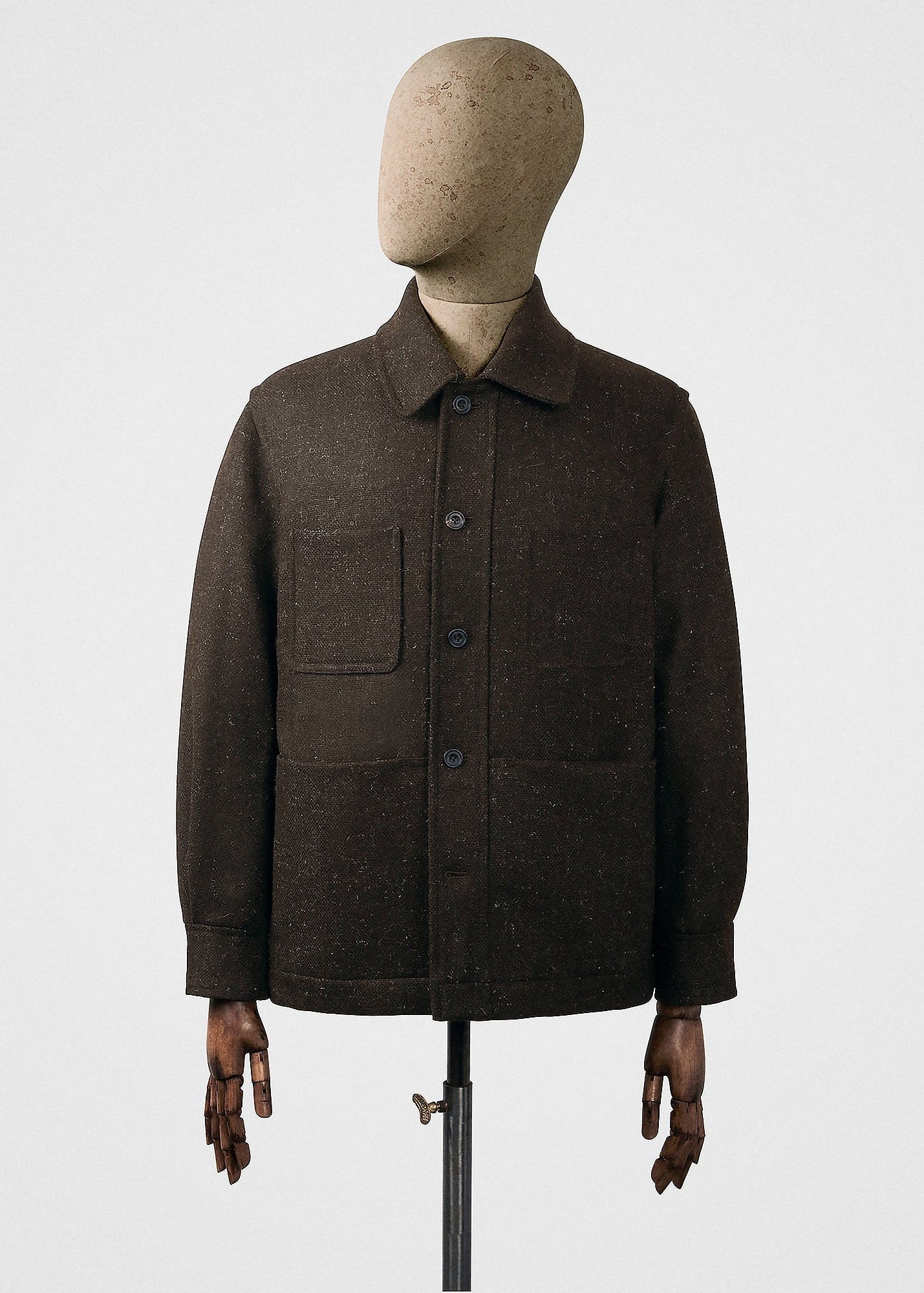 Brown coat on a mannequin against a white background